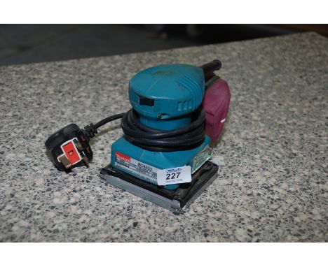 A "Makita BO4553", 240 volt Finishing Sander with dust collector.