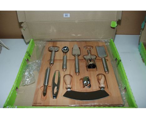 A Kitchen Tool set with beech wood base board (9 tools).