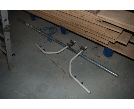 Two Bars one being an extending container lorry load-dividing/securing bar, the other being a tubular support bracket.