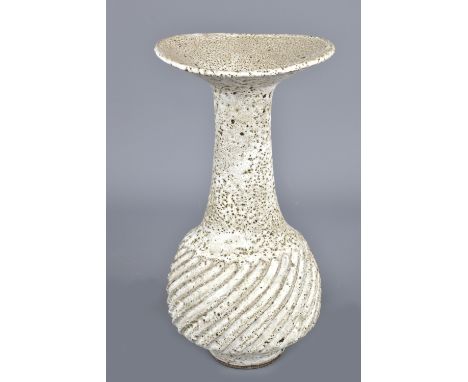 LUCIE RIE (1902-1995); a fluted stoneware bottle with flared rim covered in pitted off white glaze, impressed LR mark, made c