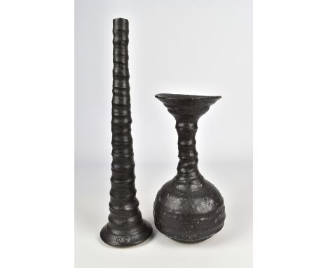 GILLES LE CORRE (born 1956); a stoneware pipe bottle and a tall stem vase both covered in black glaze, impressed marks, talle