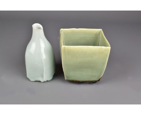 MARGARET CURTIS (born 1955); a square porcelain vase and a faceted bottle covered in celadon glaze, impressed MC marks, talle