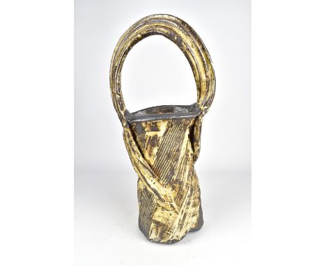 RUTHANNE TUDBALL (born 1948); a twisted faceted soda glazed stoneware basket, impressed mark, height 51cm. (D)Provenance: Pur