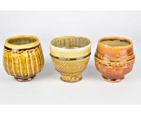 BRANDON PHILLIPS; two wood fired stoneware yunomi and one salt/soda fired yunomi, impressed BP marks, tallest 10cm (3).Philli