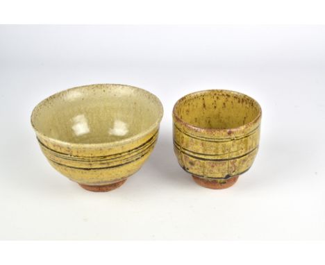 JIM MALONE (born 1946); a stoneware bowl and a yunomi both covered in ash glaze, impressed JM and L (for Lessonhall) marks, b