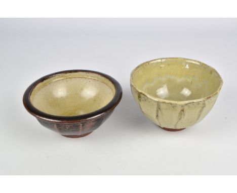 JIM MALONE (born 1946); a cut sided stoneware bowl covered in nuka glaze and a similar example covered in tenmoku breaking to