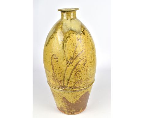 JIM MALONE (born 1946); a tall stoneware bottle covered in granite and ash glaze with nuka pours and incised grasses, impress