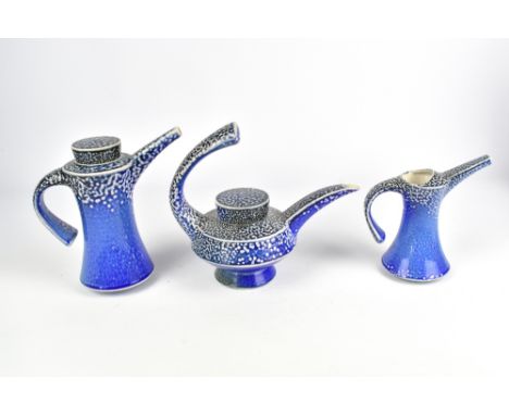 JEREMY NICHOLS (born 1948); a salt glazed teapot, coffee pot and jug, impressed JN marks, tallest 19.5cm (3). (D)Provenance: 
