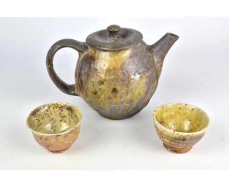 NIC COLLINS (born 1958); a wood fired stoneware teapot with fused cover and a pair of cups, tallest 16cm (3). (D)Provenance: 