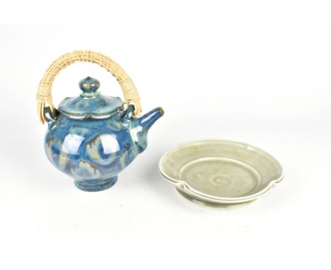 SARAH JAEGER (born 1949); a porcelain teapot with cane handle covered in lustrous glaze and a shallow dish with double rim, i