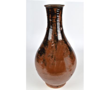 JIM MALONE (born 1946); a stoneware bottle of Korean form covered in tenmoku breaking to kaki glaze, impressed JM and L (for 