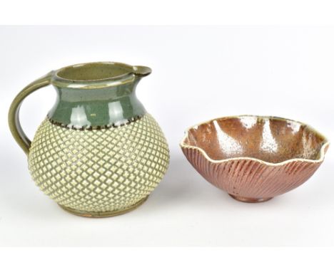 MARK WILLIAMS; a stoneware pitcher with diamond pattern covered in green glaze and a fluted wood fired stoneware bowl, incise