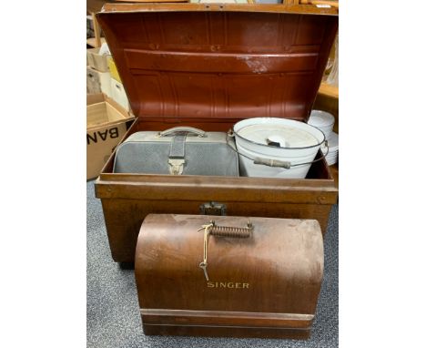 A vintage tin trunk, together with an enamelled bucket, sewing machine and other items.