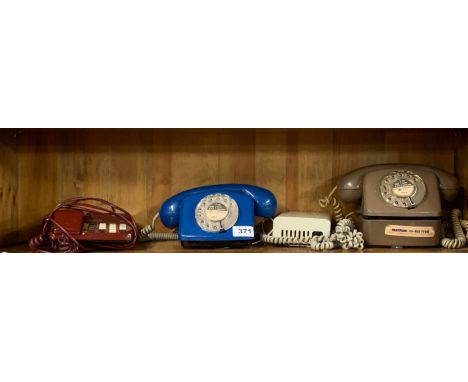 Three vintage telephones.