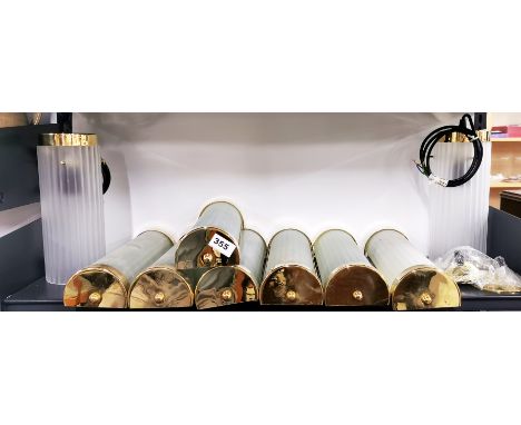 A set of seven gilt brass and glass wall lights with two matching pendant lights, wall light L. 37cm.