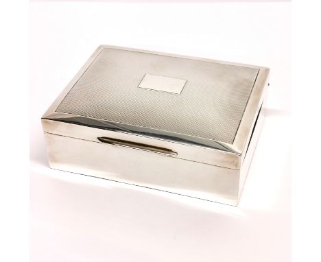 A hallmarked silver covered cigarette box with engine turned decoration, 11.5 x 8.5 x 4cm.