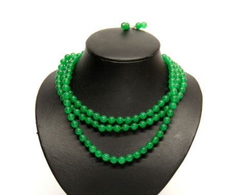 A lovely three strand green jade necklace on an 18 carat white gold plated clasp with matching earrings.