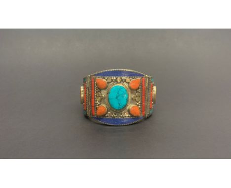 A Tibetan white metal stone set Kampa Tribe hinged bangle. W. 5.5cm, internal Dia. 6.2cm.