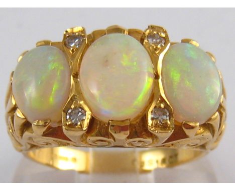 An 18 carat gold opal and diamond ring, hallmarked London 1975, the principal opal measuring approx 19 x 16.5mm, ring size P,