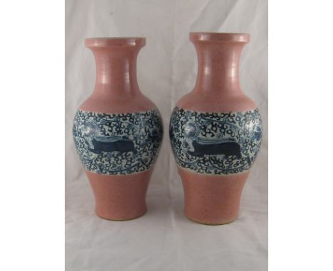 A pair of large 19th. century Oriental ceramic vases with broad blue and white band of temple lions on the otherwise lilac bo