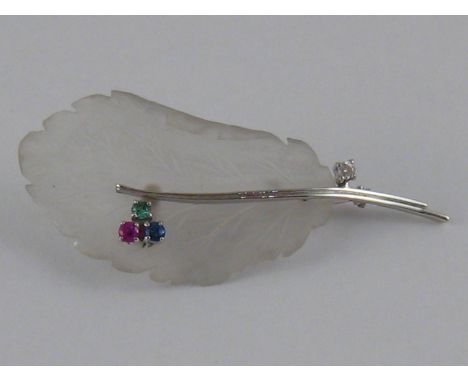 A white metal (tests 18 carat gold) carved Chalcedony, emerald, sapphire, ruby and diamond brooch, designed as a leaf, approx