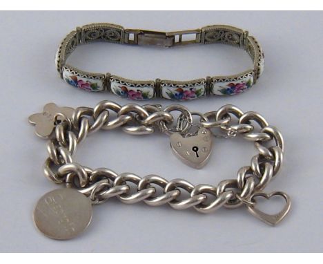 A mixed lot comprising a heavy silver curb link bracelet with three charms (57.5 gms) and a white metal bracelet with ceramic