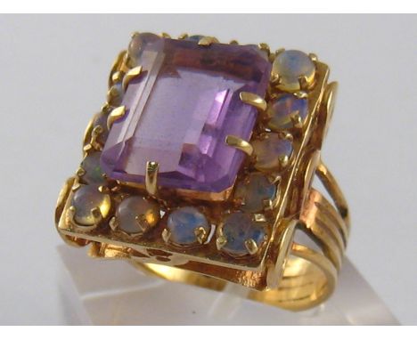 A yellow metal (tests 14 carat gold) amethyst and opal ring, unascribed continental hallmarks, amethyst approx 12 x 10mm, rin