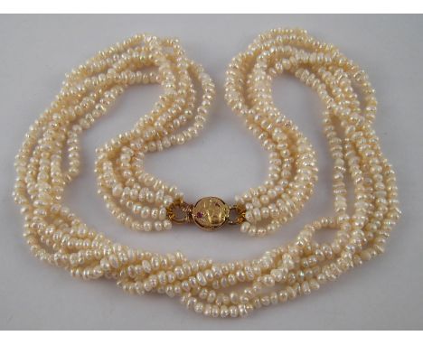 A five row freshwater cultured pearl necklace, approx 48cm long, with a yellow metal (tests 9 carat gold) ruby and diamond cl