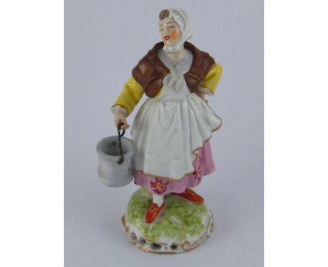 A 19th. century ceramic figure of a milkmaid . Ht. 15cm. 