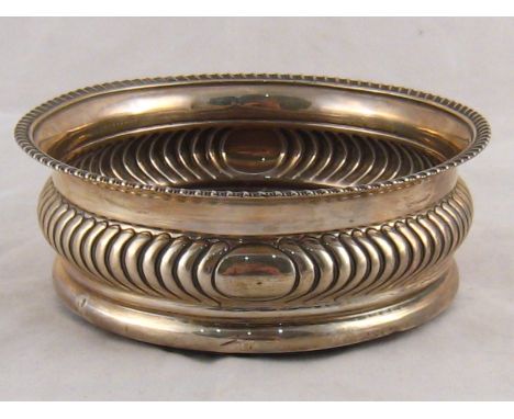 A large Georgian silver decanter coaster with ribbed bellied sides and gadrooned rim. Solomon Hougham, London 1816. 