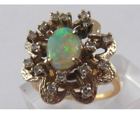 A yellow metal (tests 14 carat gold) opal and diamond ring, opal approx 9 x 6mm, ring size L, 6.8 gms.
