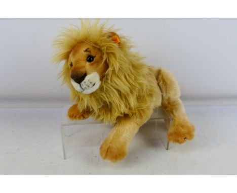 Steiff - An unboxed Steiff Lion #065668 with tags (50cm long from nose-tail). Item appears to be in very good-excellent condi