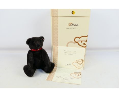 Steiff - A boxed limited edition Steiff Teddy bear in black. This alpaca mohair jointed bear is 32 cm tall with red leather c