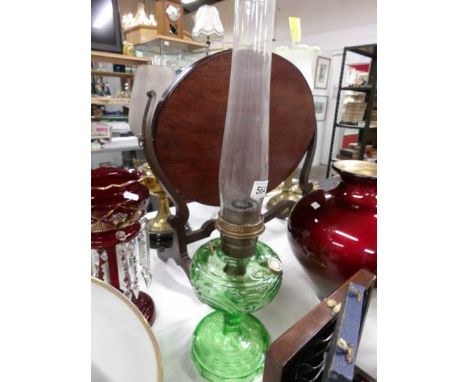 A 1940's Aladdin 'Washington Drape' green glass oil lamp