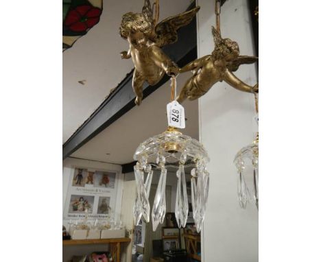 A hanging cherub ceiling light
 
These are both Spelter
Late 20th century
 
