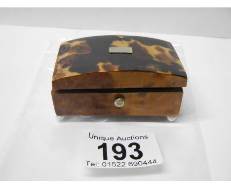 A tortoise shell snuff box