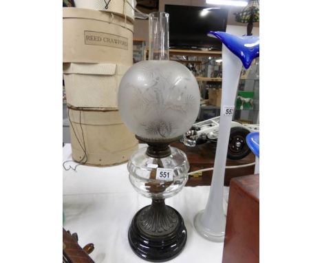 A Victorian oil lamp with glass font and etched shade