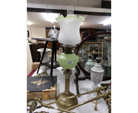 A Victorian brass corinthian column oil lamp with mottled green glass font and later shade