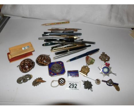 A collection of enamel badges including police and a quantity of pens