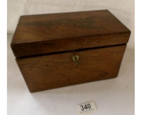 A mahogany tea caddy with key