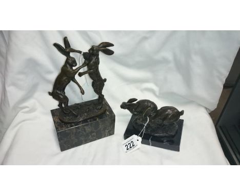 2 bronze statues of hares on marble bases, boxing/running, both signed Nike