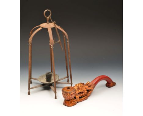 AN INDIAN IRON CANDLE HOLDER with wax tray, 36cm high and an oriental lacquered taper stick holder in the form of a dragon, 5