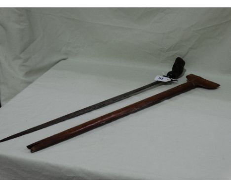 A Tribal Short Sword And Scabbard With Carved Wooden Grip