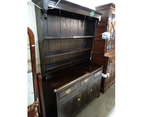 An Early 20th Century Reproduction Dark Oak Cottage Dresser With Cupboards And Drawers To The Base And Three Shelf Rack