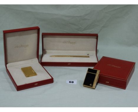 A Boxed Dupont Of Paris Gold Plated And Black Enamel Lighter Together With A Boxed Dupont Gold Plated Lighter And Boxed Dupon