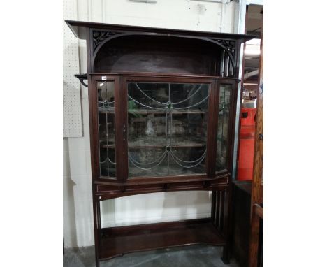 An Arts And Crafts Period Mahogany Display Cabinet With Leaded And Glazed Cupboard And Open Base Shelf