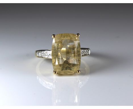 A 9ct yellow gold ring set yellow quartz and diamond shoulders sold together with box