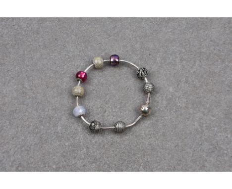 A Pandora bracelet with nine silver ball charms in a Pandora box. *Very good condition, with just very light surface scratche