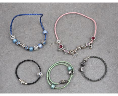 A group of five Pandora leather necklaces and bracelets with silver charms comprising three woven leather necklaces and two b