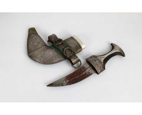 An early 20th century Omani Khanjar dagger steel blade, waisted horn hilt with silver (white metal) mounts, decorative silver